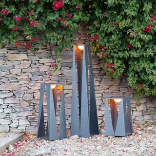 Teatree Lantern small, medium large with ykary bulb outdoor by rock wall and pebbles floor