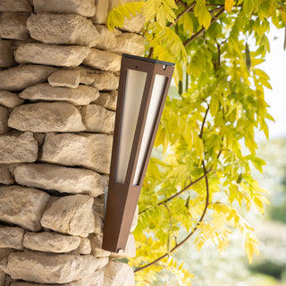 Lanai solar torch corten aluminum hanging on stone wall