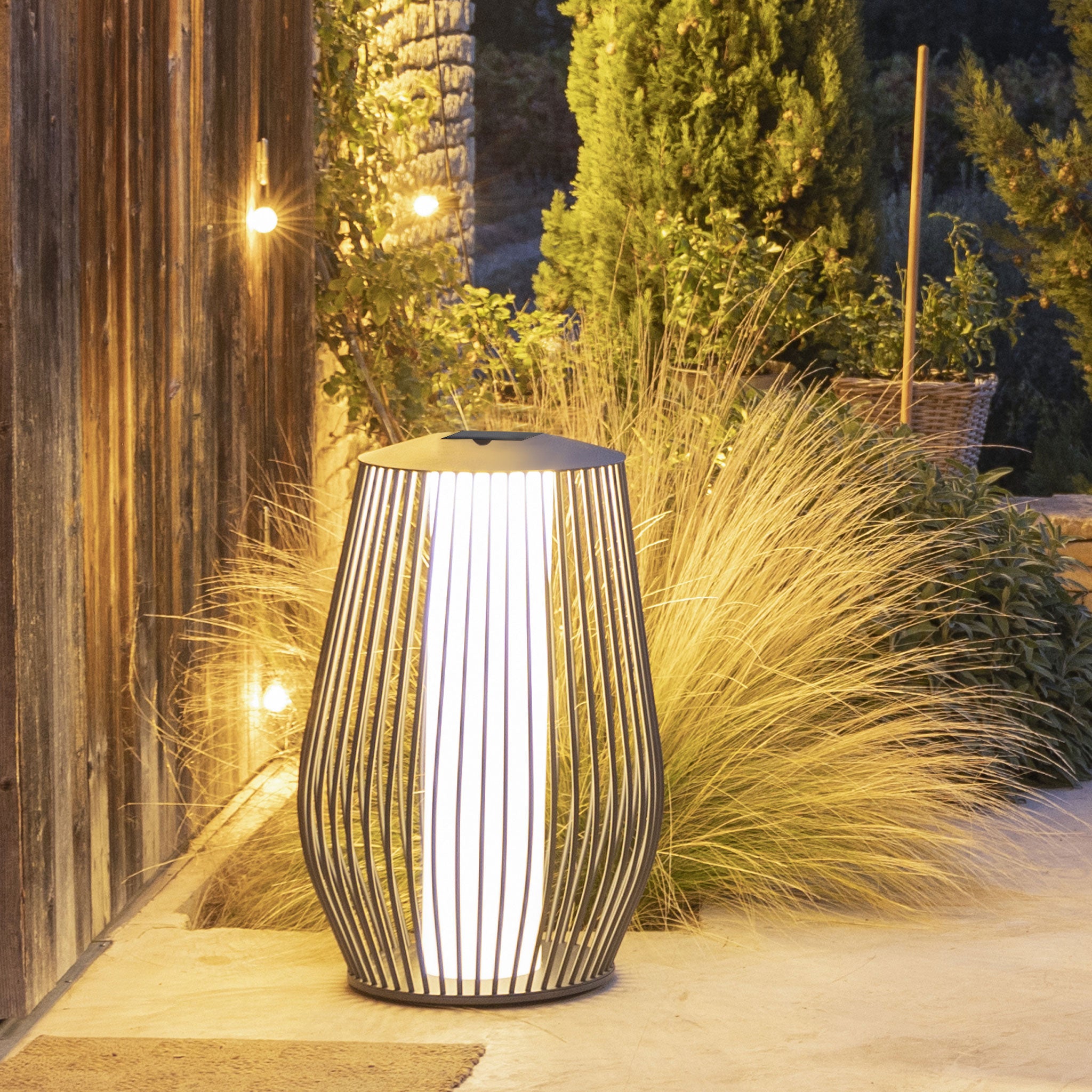 Mandalay solar floor lamp lighting up outdoor backyard