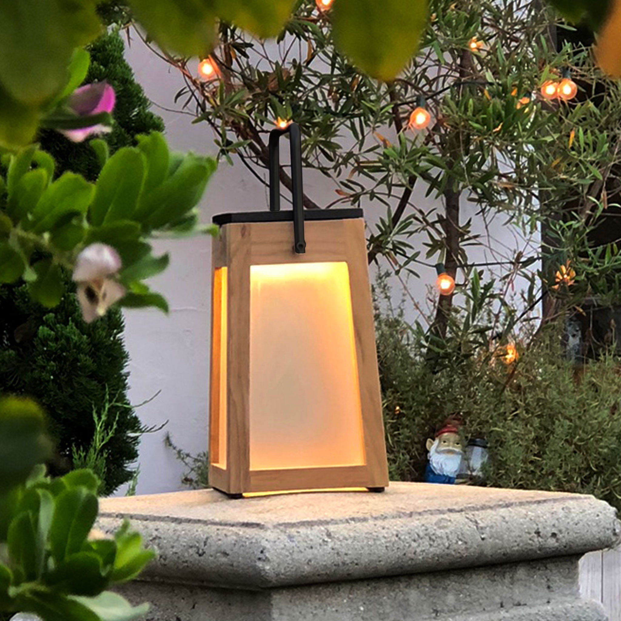 Tecka solar lantern teak lighting up garden