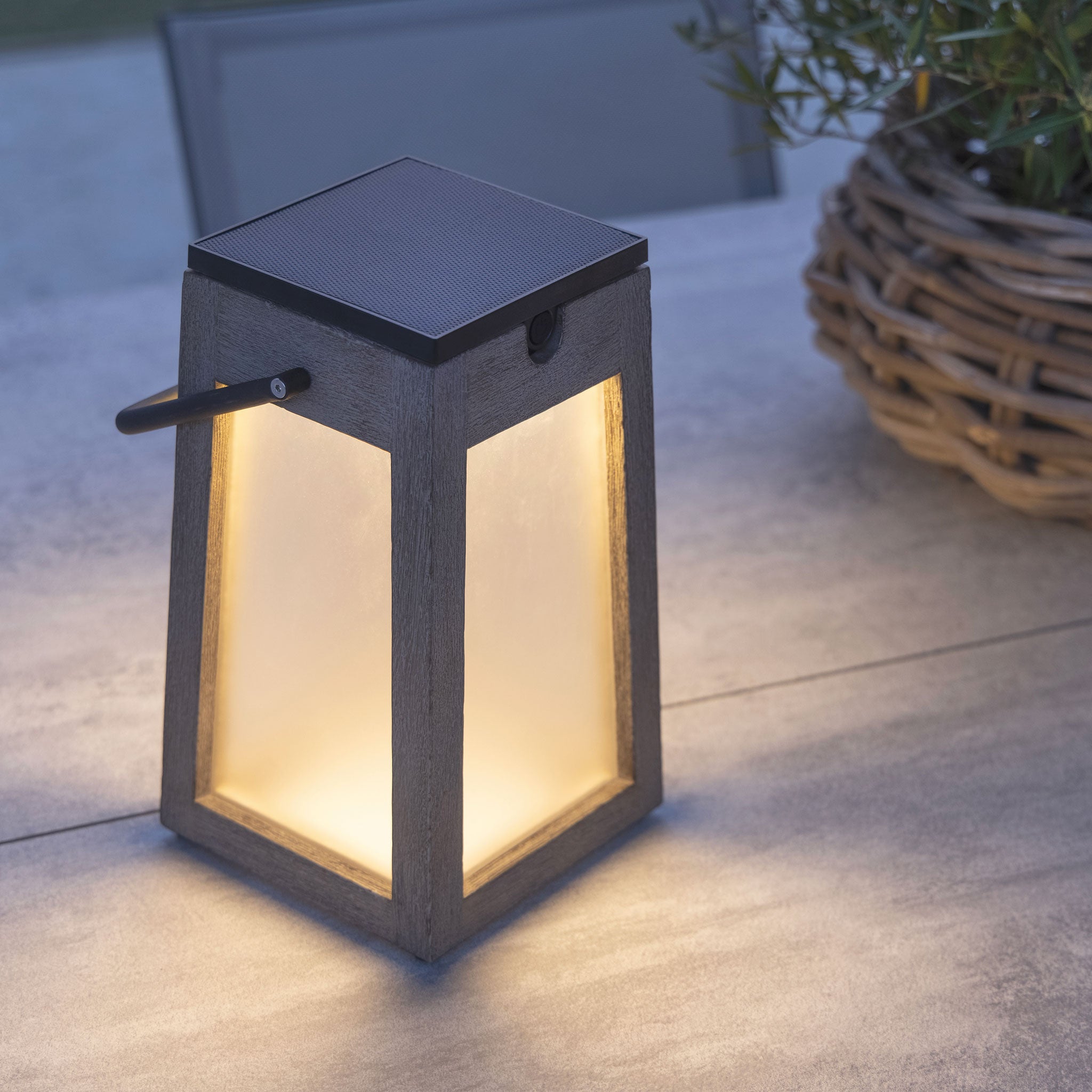 Tecka solar lantern weathered teak finish on table top